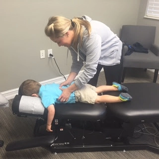 Chiropractor Naples FL Hillary Weiland Adjusting Kid